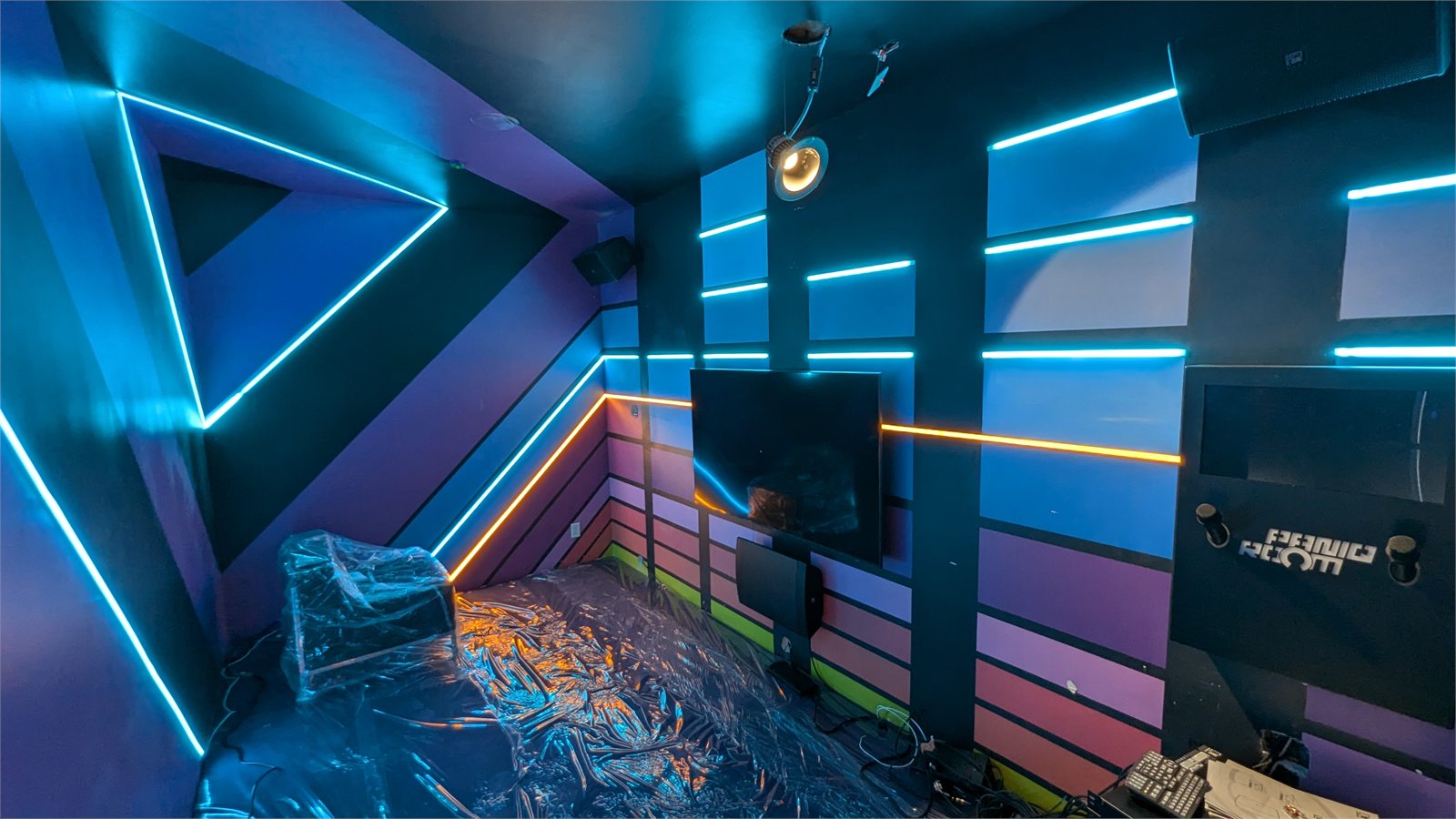Custom LED-lit studio interior with geometric wall fabrication