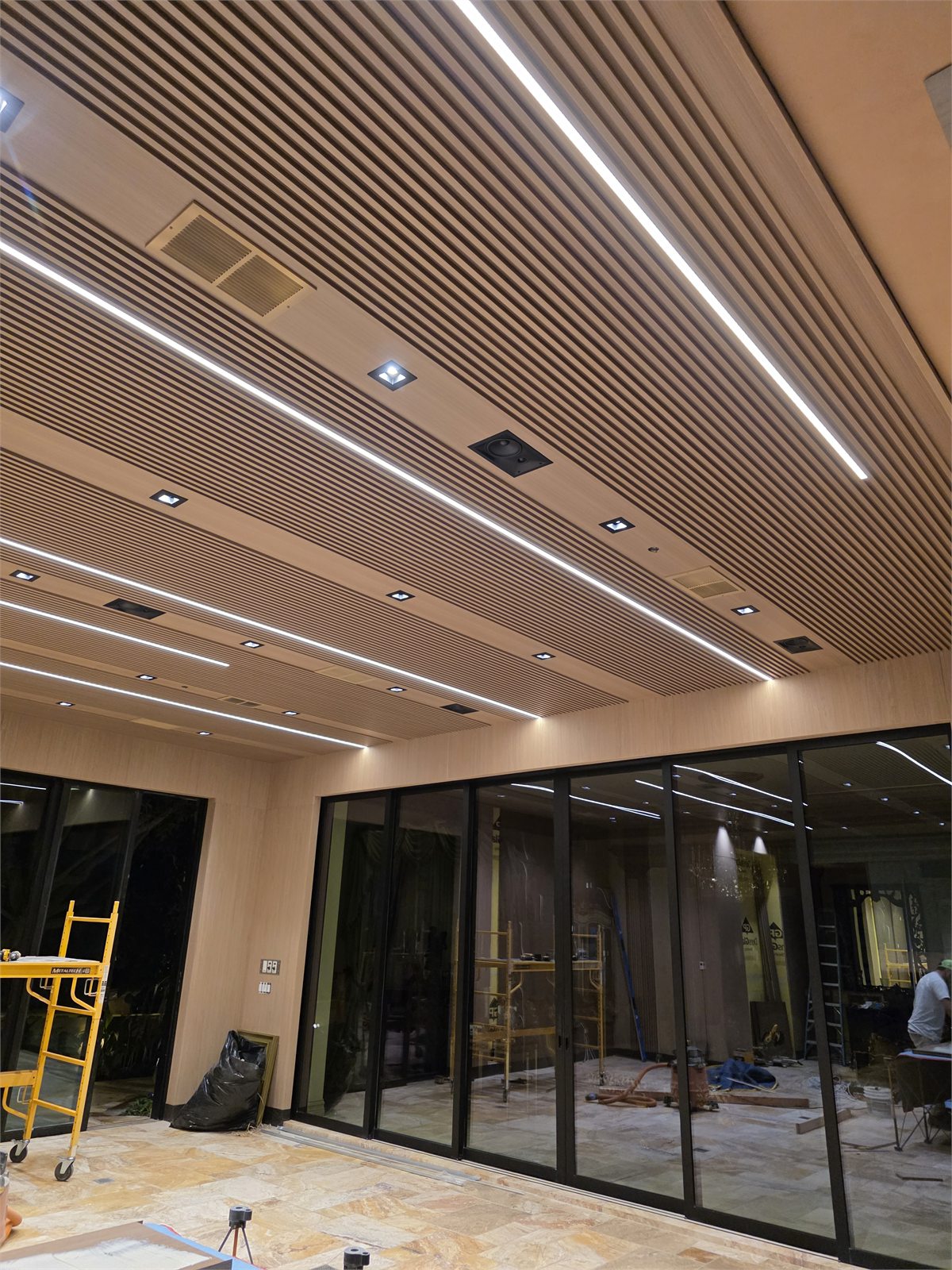 Custom wood slatted ceiling with integrated linear lighting